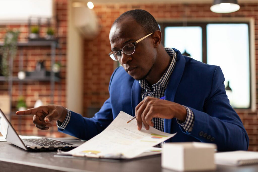 business man analyzing papers on clipboard to plan 2022 01 13 00 41 54 utc